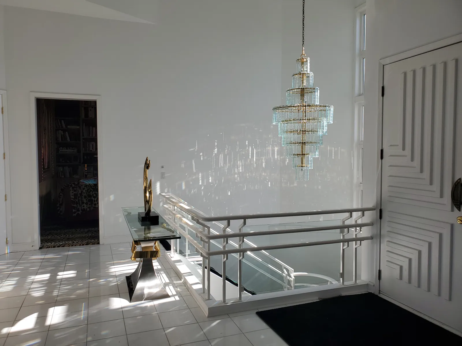 White foyer with crystal chandelier