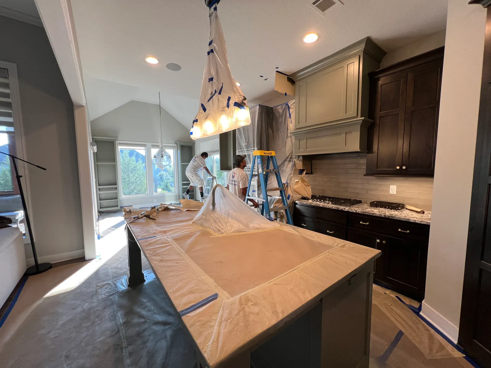 Kitchen masked and taped for painting